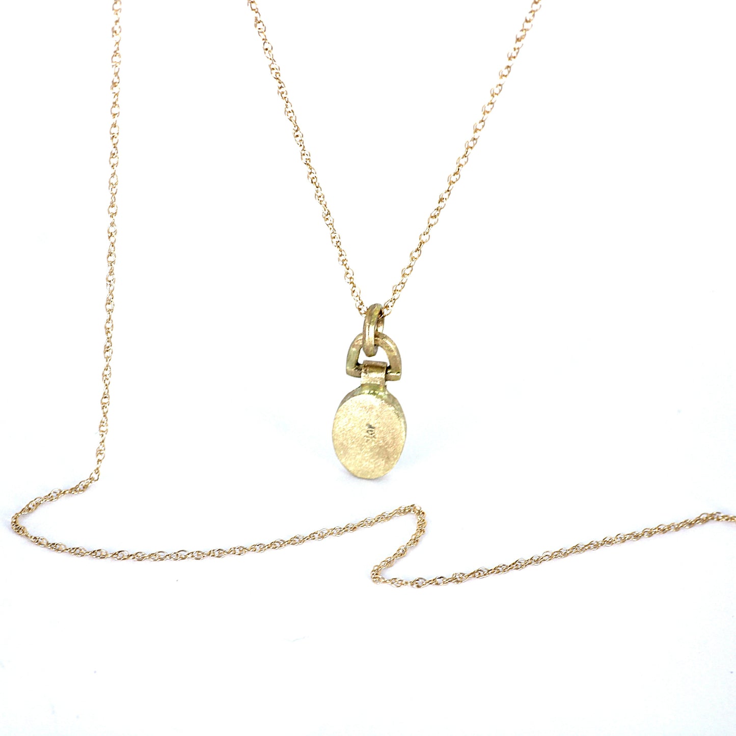 A delicate gold chain necklace with a small oval pendant and a ring-like connector, displayed on a plain white background.