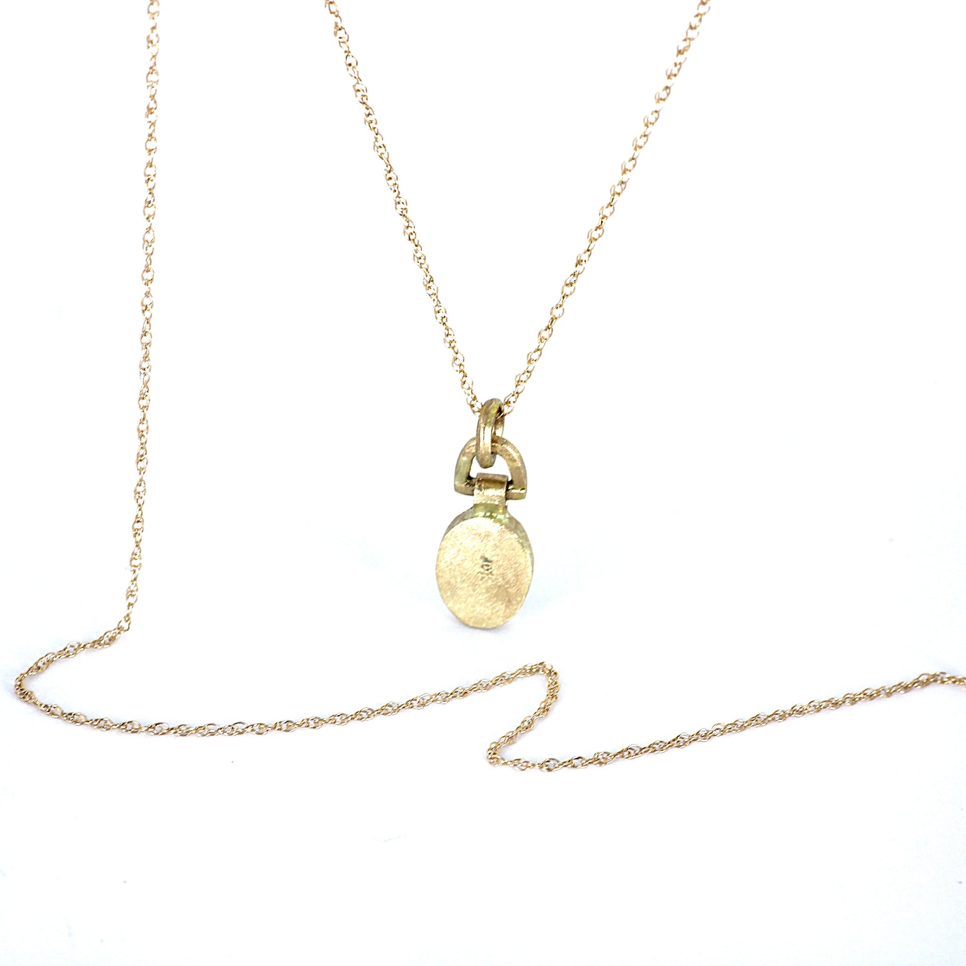 A delicate gold chain necklace with a small oval pendant and a ring-like connector, displayed on a plain white background.
